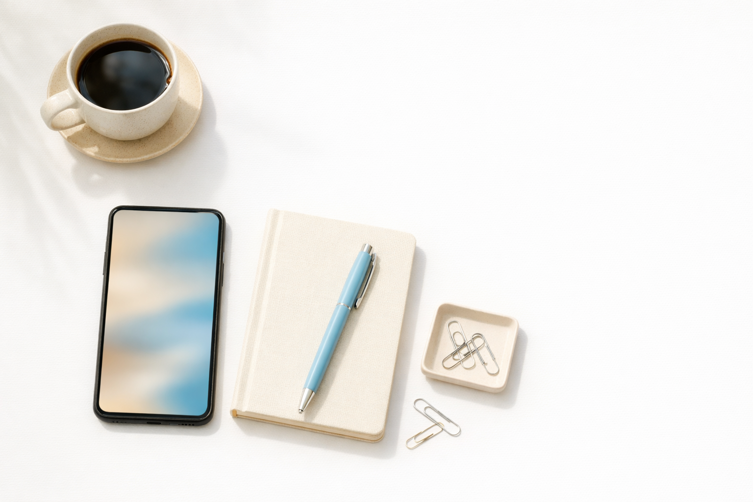 Smartphone on a clean desk with minimal office items and soft natural light, representing an Instagram authority strategy for local businesses.