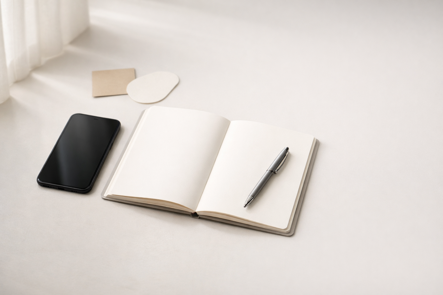Minimalist desk scene with smartphone and notebook representing a non-generic social media content strategy